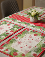 A festive dining table set with the Pine Needle & Polka Dot runner and mats, featuring a white floral centerpiece that complements the snowflake and pine motifs.
