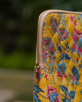 A close-up side view of the bag, focusing on the high-quality quilted texture and the secure cream-toned zipper with polished gold-toned hardware.