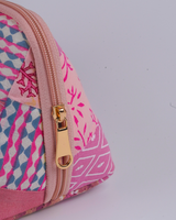 An angled perspective from above, emphasizing the gold-toned zipper hardware and the intricate floral vine prints across the top panels.