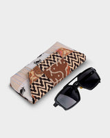 An angled view of the case shown alongside a pair of dark sunglasses to demonstrate its practical $7"$ length and protective, structured form.