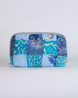 A straightforward horizontal view of the pouch, highlighting the symmetrical arrangement of the quilted textile blocks and the top-mounted zipper.