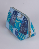 An angled perspective from above, emphasizing the detailed hand-quilted texture and the way the indigo and ocean blue patterns wrap around the structured frame.