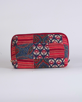 A front-facing studio shot of the Crimson & Indigo Floral Quilted Pouch against a clean white background, showcasing the sophisticated patchwork of deep red and navy floral patterns.