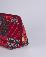 A side profile view showing the pouch’s wide-bottom, triangular structure that allows it to stand upright independently.