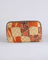 A straightforward horizontal view of the pouch, highlighting the symmetrical arrangement of the hand-quilted panels and the sleek zipper closure.