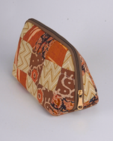 An angled perspective from above, emphasizing the detailed ikat and chevron patterns and the structured, protective frame of the utility pouch.
