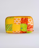 A front-facing studio shot of the Sunny Yellow & Lime Quilted Pouch, showcasing the vibrant yellow and green patchwork with traditional Indian Bandhani and Leheriya motifs.