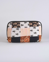 A front-facing studio shot of the Onyx & Clay Floral Quilted Pouch, showcasing the sophisticated patchwork of black, white, and terracotta-orange botanical prints.