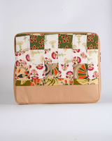A handcrafted quilted laptop bag featuring a sophisticated patchwork mosaic of sage green, cream, and terracotta floral prints. The design includes a smooth, tan-colored faux-leather base for a structured and professional finish.