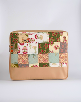 Back view of the quilted laptop bag, highlighting the earthy patchwork patterns of sage and terracotta above a solid tan-toned bottom panel.