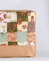 A full vertical view of the laptop bag, showcasing the intricate hand-quilted texture and the slim, protective structure of the tech sleeve.