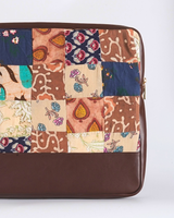 A side-angle vertical view of the laptop bag, showcasing the slim, protective structure and the contrast between the intricate patchwork and the solid dark brown bottom.
