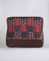 A front-facing shot of the laptop bag, highlighting the rich crimson and navy textile patterns and the structured, professional silhouette.