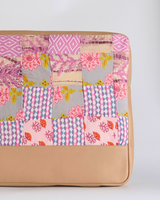 A full vertical shot of the laptop bag, showing the artisanal hand-quilted texture and the elegant transition from the patchwork fabric to the solid tan base.
