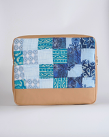 Back view of the Indigo & Azure Batik quilted laptop bag, highlighting the square patchwork patterns in various shades of blue and the smooth tan-colored bottom.