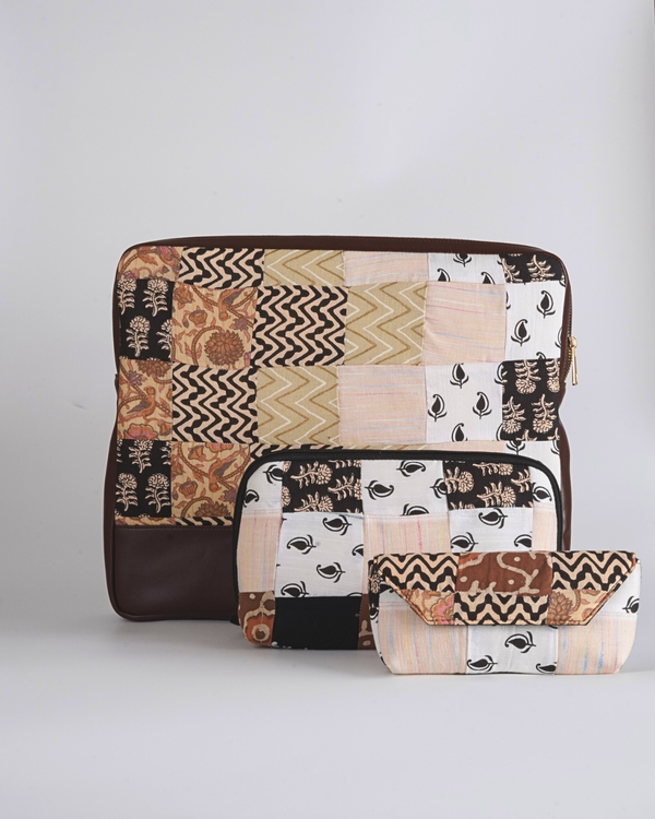 A complete set of the Cocoa & Cream Botanical Essentials Trio, showing the laptop bag, utility pouch, and eyewear case arranged to display their matching cream and cocoa botanical patchwork and dark brown bases.
