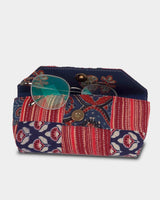 A view of the case partially open with a pair of glasses inside, demonstrating the secure internal compartment and the soft, protective lining.