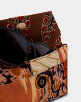 A view of the case partially open, revealing a pair of dark sunglasses resting inside the secure, protective internal compartment.