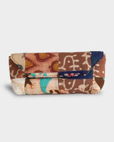A front-facing studio shot of the Indigo Patchwork Quilt Eyewear Case, showcasing its structured envelope design and a rich mosaic of navy, turquoise, and earthy brown patterned blocks.