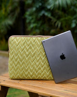 The Sage Zigzag Quilted iPad Sleeve standing on a wooden table next to a grey iPad.