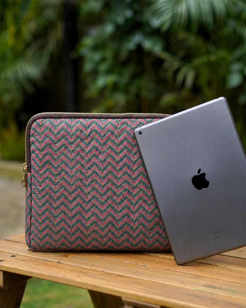 The Teal & Terracotta Zigzag Quilted iPad Sleeve standing on a wooden table next to a grey iPad.