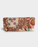 A clear, horizontal view of the case lying flat, highlighting the intricate arrangement of global-inspired textile prints and the thick, protective quilting.