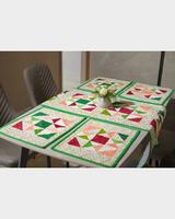 A top-down perspective of the full table arrangement, illustrating the symmetrical placement of the pinwheel mats around the central runner.